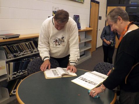 Grand Haven Alumni take advantage of the yearbook archive in the library.