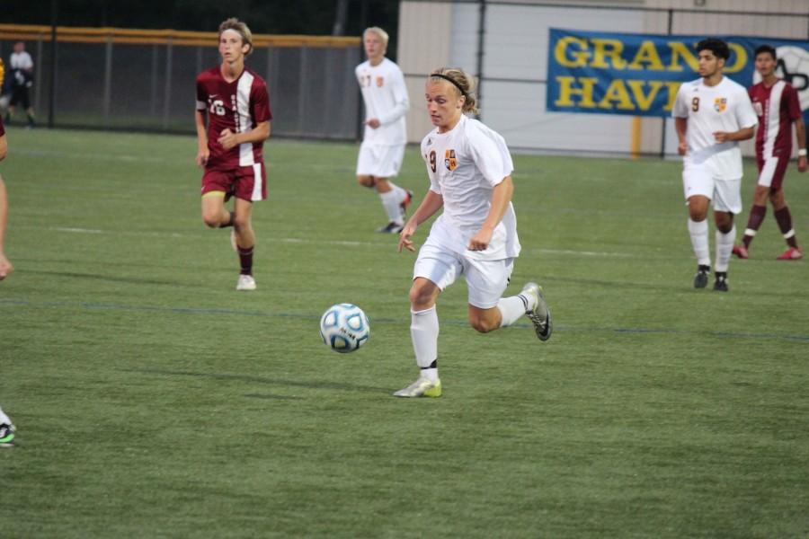Junior Connor Jettner dribbles the ball down the field in last weeks victory over Grandville,2-0.