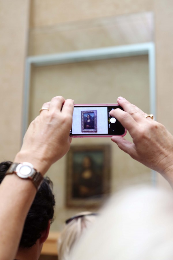 The Louvre Museum in Paris holds one of the words most famous paintings, the Mona Lisa by Leonardo da Vinci. Hundreds gather daily to view the painting, many and almost all snapping pictures of her beauty.