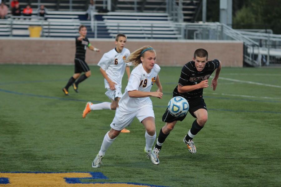 Junior Connor Jettner races Rockford defender to the ball in a home contest on Tuesday, Sept. 16. Jettners constant pressure on the Rams defense helped the Bucs win 2-0. 