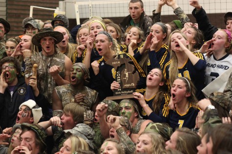 The team celebrates with the student section after receiving the regional trophy.  