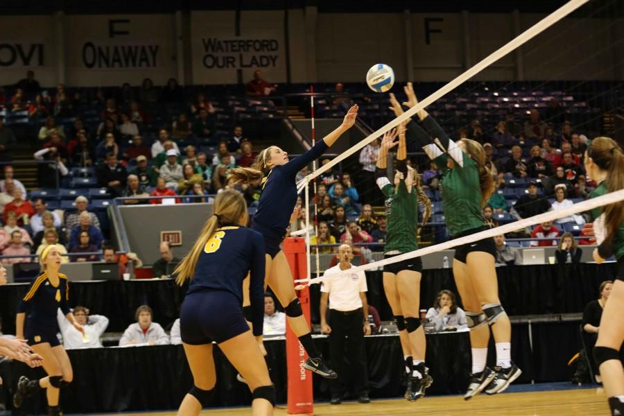 Middle hitter Kenzie Ritzema reaches to tip the ball over the block set up by Novie players. 