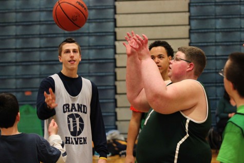 Junior Drew Hewitt tosses the jump ball in the air with Brennan during the game.