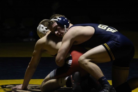 Senior 135-pound wrestler Evan Johnson breaks down East Kentwood wrestler Zsingmond Squires, in a match on Feb. 2. Johnson defeated Squires in a 10-6 decision, the Bucs defeated the Falcons 56-15. 