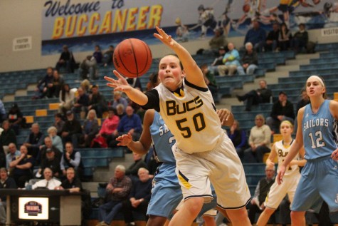 Sophomore Lynn Olthof passes the ball in a game against Mona Shores on Dec. 12. The Bucs fell to Sailors 38-31.