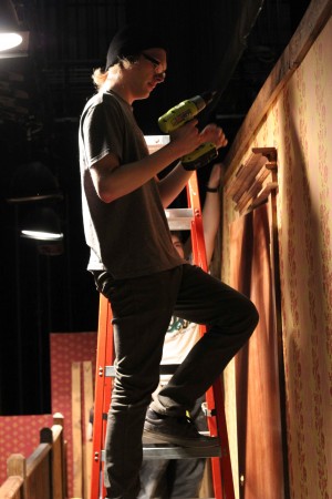 Sophomore David Slocum handles the power tools on the second story of the stage. Slocum will be performing in the show Noises Off.  
