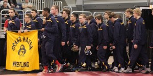 The Buccaneer wrestling squad marches around Kellogg Arena before the start of state quarterfinals. The last time the team made it to state was 2012.