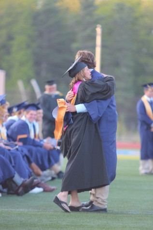 Principle Tracy Wilson embraces senior Luke Larkin after receiving his diploma. 