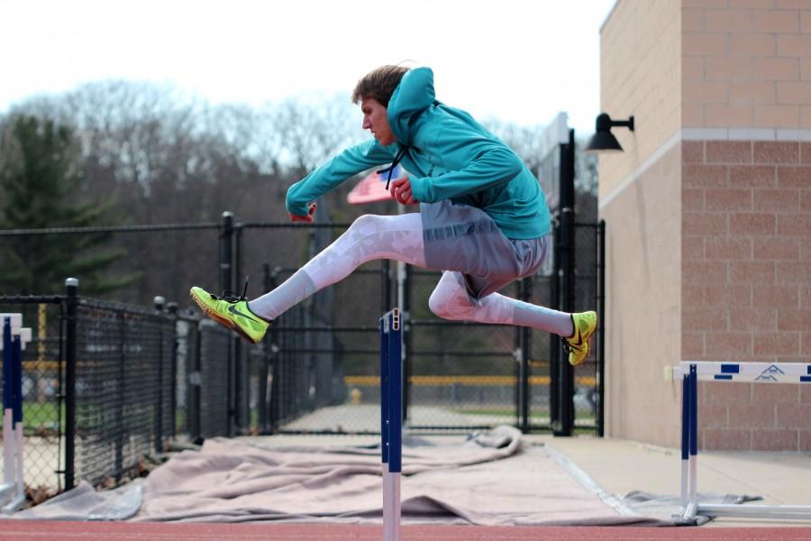 Gliding over: Casey soars smoothly across the 110 meter hurdle during a practice this past spring. The height for mens 110 meter high hurdle is 3.5 feet tall with 10 hurdles per lane.