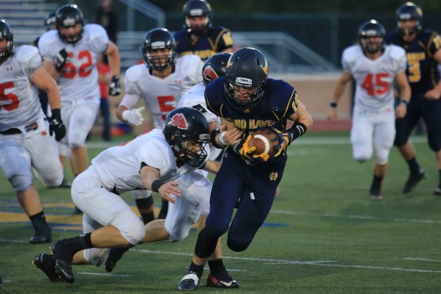 Senior Lukas Steffel tries to avoid a Lowell defender on Friday night. Steffel is second in scoring this season for the Bucs with four touchdowns. 