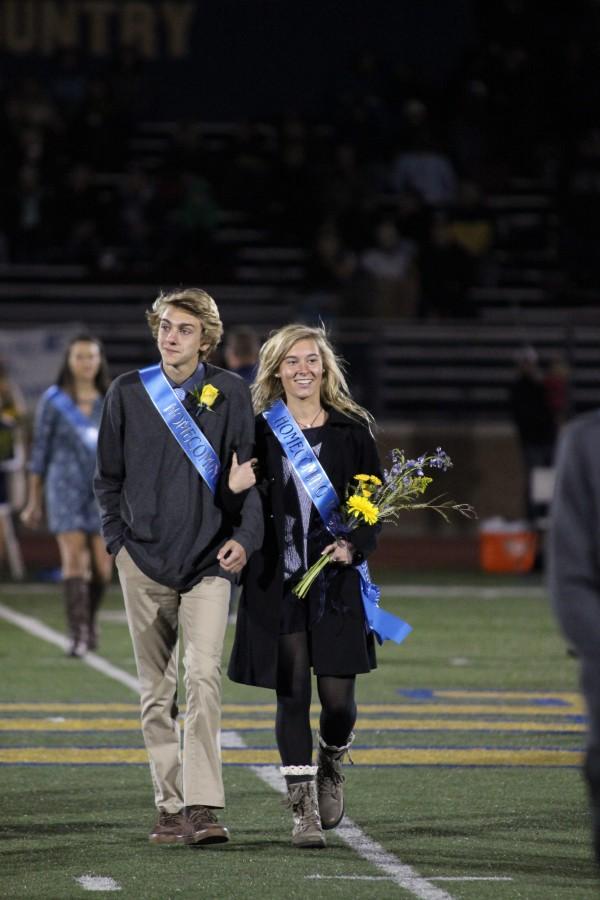 Sophomore couple Jack Nicholson (left) and Julia Drabczyk (right) hold each other close at the Homecoming game. This was Nicholsons second time on the Homecoming Court and while these memories are close to his heart, Nicholsons still quick to remember the time he forgot to wear pants to school. 