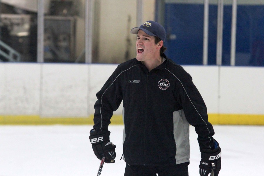 +Coach+Keegan+Ferris+takes+a+hands+on+approach+during+the+first+week+of+hockey+practice.+Ferris+previously+coached+at+Forest+Hills+Central+and+graduated+from+Grand+Valley+University+in+2014.