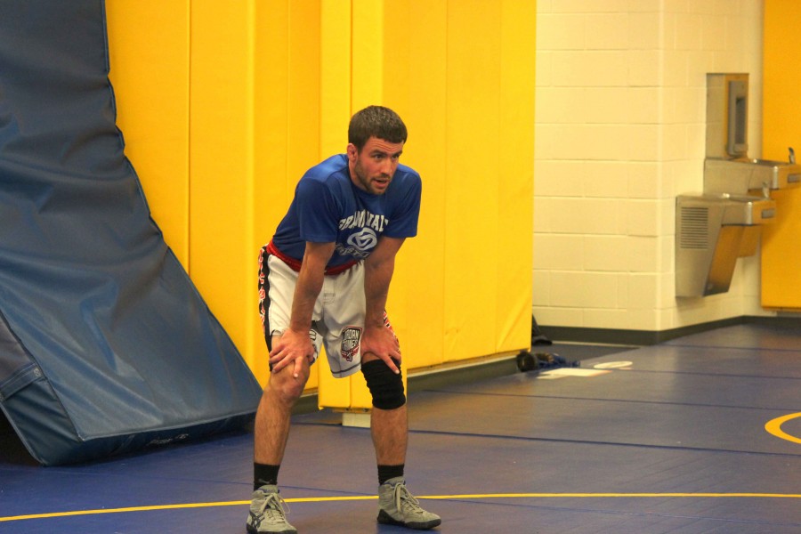 Varsity wrestling coach, Vincent Gervais, observes as wrestlers run drills during the first week of practice. Gervais was previously the assistant varsity coach for the Bucs but stepped into the role of head coach this season after former coach James Richardson announced his retirement. 