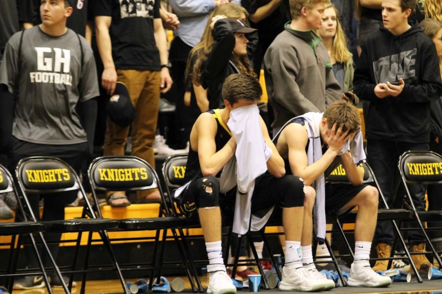 Junior Zac Holman and Senior Drew Hewitt take a seat at the end of the game as their season comes to  an end and their years of playing high school basketball together.The last quarter was really intense, they hit a lot of tough shots and were really hard to stop. But we had an answer for just about everything they threw at us, Hewitt said.