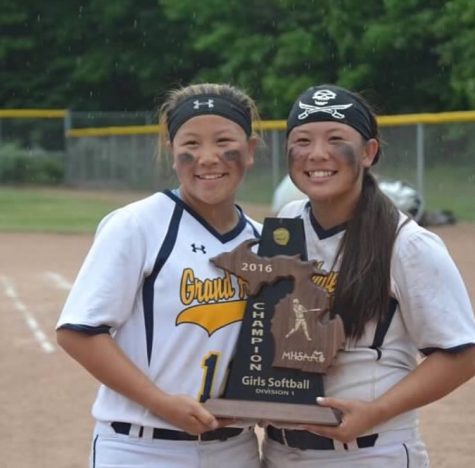 Sisters Yogi (right) and Baby Hang embrace a moment with the district trophy Saturday night.