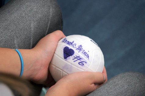 A member of the young Bucs’ Team, an elementary school volleyball program, holds senior Kennedi Bernia’s ball.
