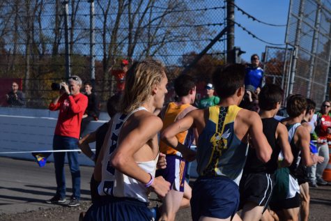Junior Jack Nicholson looks to pass opposing runners during the state meet. Individually, Nicholson finished 13th overall, earning him All-State honors.