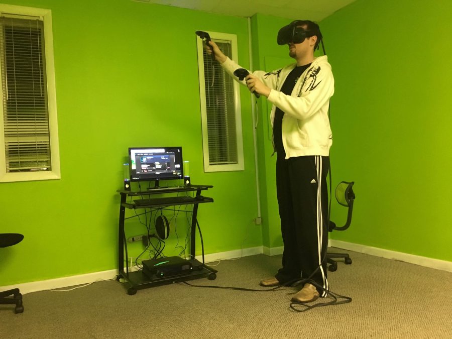 Jason Baumgart wears a headset, sending him into                                this virtual world.