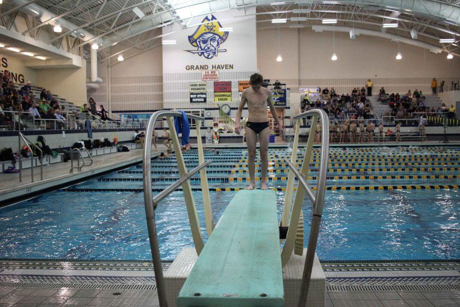 Freshman Carter Jones-Hirr lines up his feet at the end of the board before executing his backwards dive.  