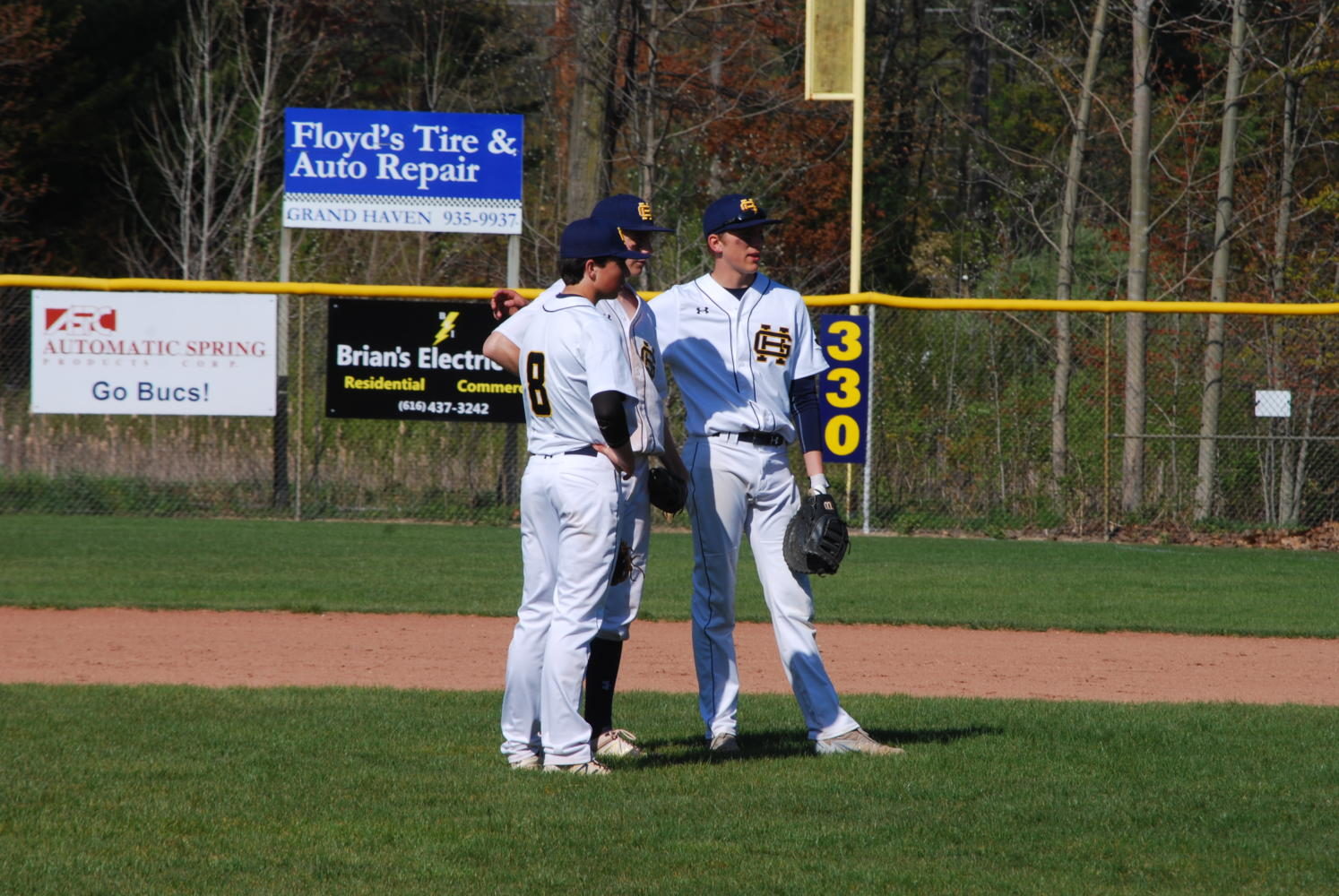 Bucs ball players discussing the game plan in between innings.