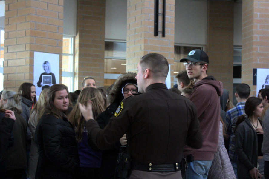 Officer Ryan DeVries gives students directions before they walk outside.