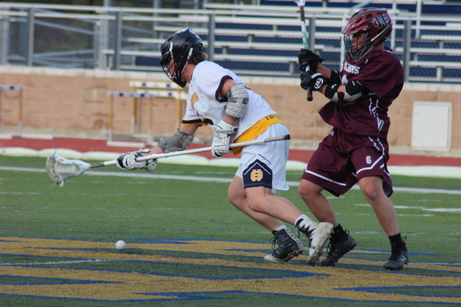 Junior Trevor Holleman charges to a ground ball in a match earlier in the season. Holleman kept the Bucs in the tense rivalry contest against Spring Lake