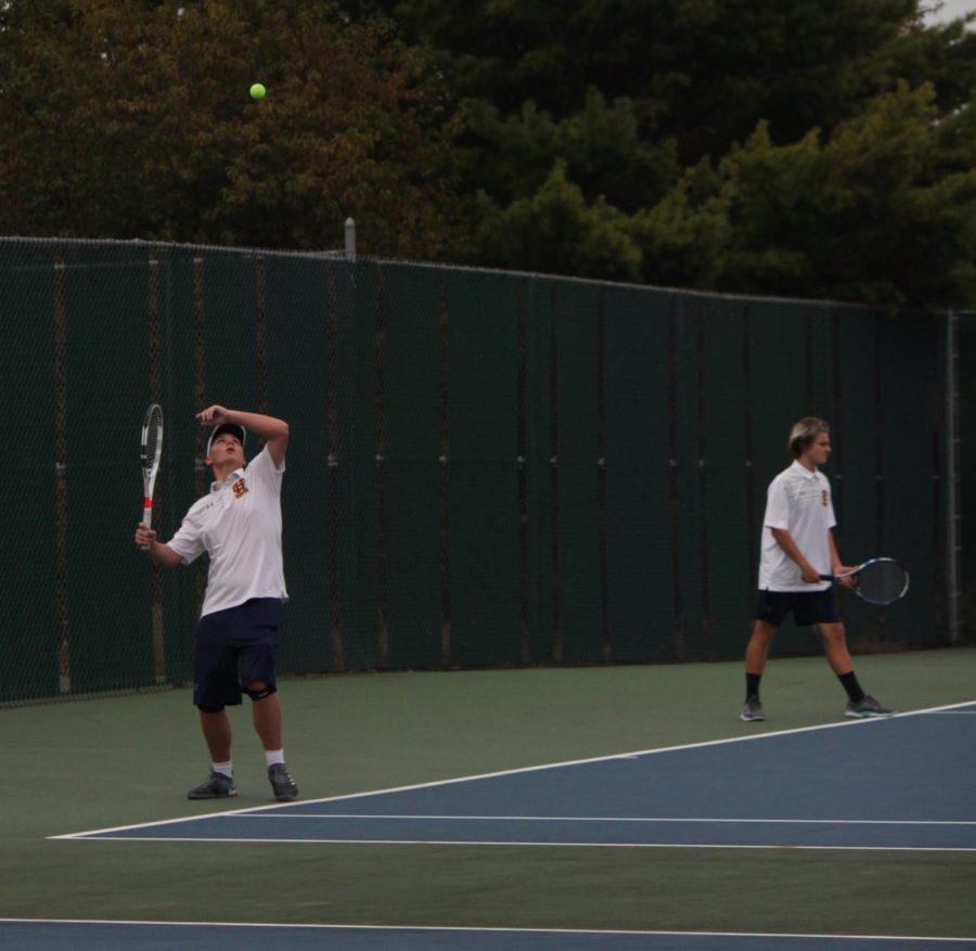 Junior Weston Taylor prepares to deliver a serve to his opponent. Taylor has been one of biggest benefactors on the team at No. 3 singles this year. 