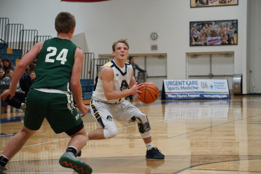 Senior point guard Casey Constant works to create space in order to find an open look for a shot against Rocket defender.
