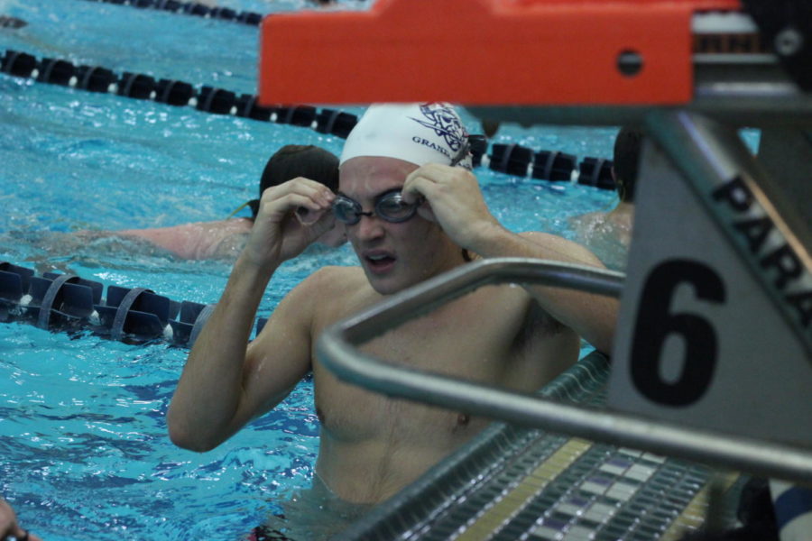 Senior Chris Akselberg puts on his goggles in prpearation for the race. The match against the Falcons will be Akselbergs last since it is Senior Night.