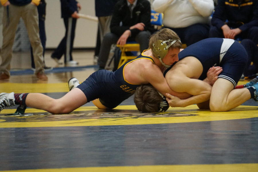 Miller wrestles a Hudsonville opponent in a home district meet. He has been the Bucs No. 1 wrestler this year with a near-perfect record.