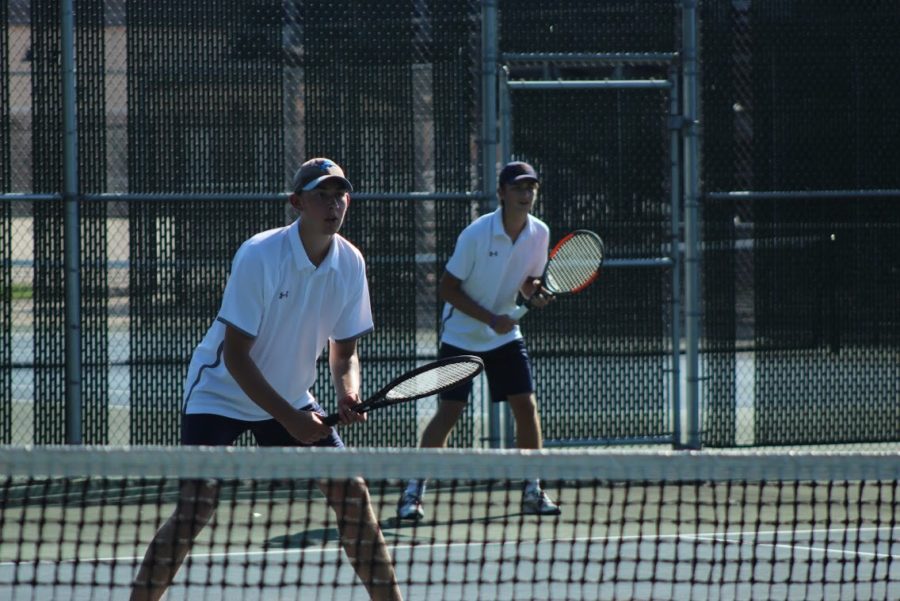 Junior doubles player Tyler De Gram and his partner await an opposing serve. Doubles has been the weakness for the Bucs this year and poor health did not help their cause.