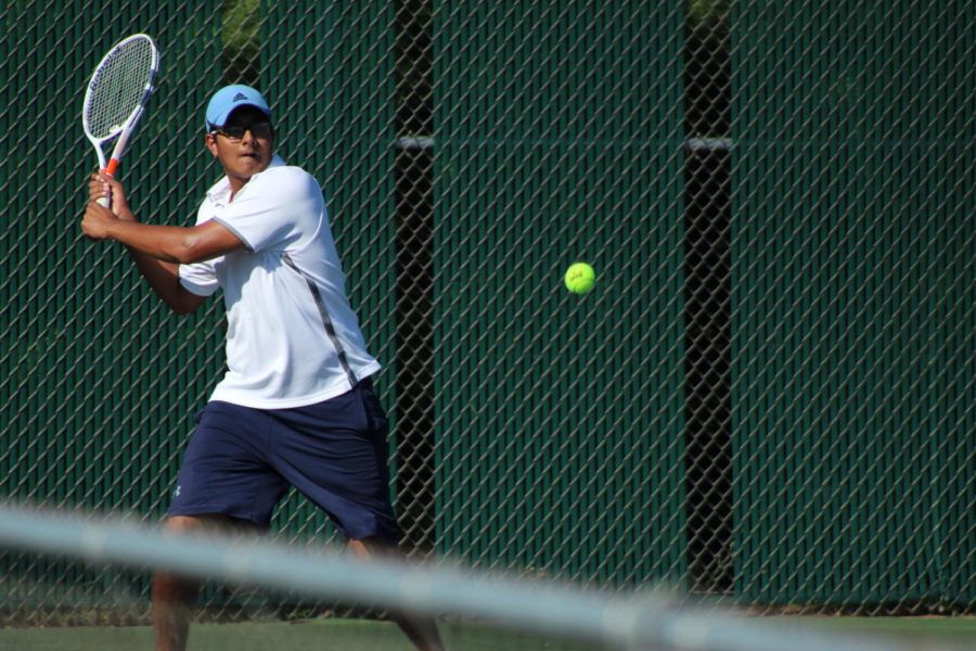 Sophomore Ashray Mandala   prepares to send the ball back to his opponent. He played doubles at the tennis match against East Kentwood on Monday September 16.