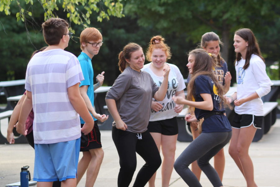 Choir students learn dance moves to  one of the many choir dances. To learn the dance they split up into small groups where they met new people and learned new moves.