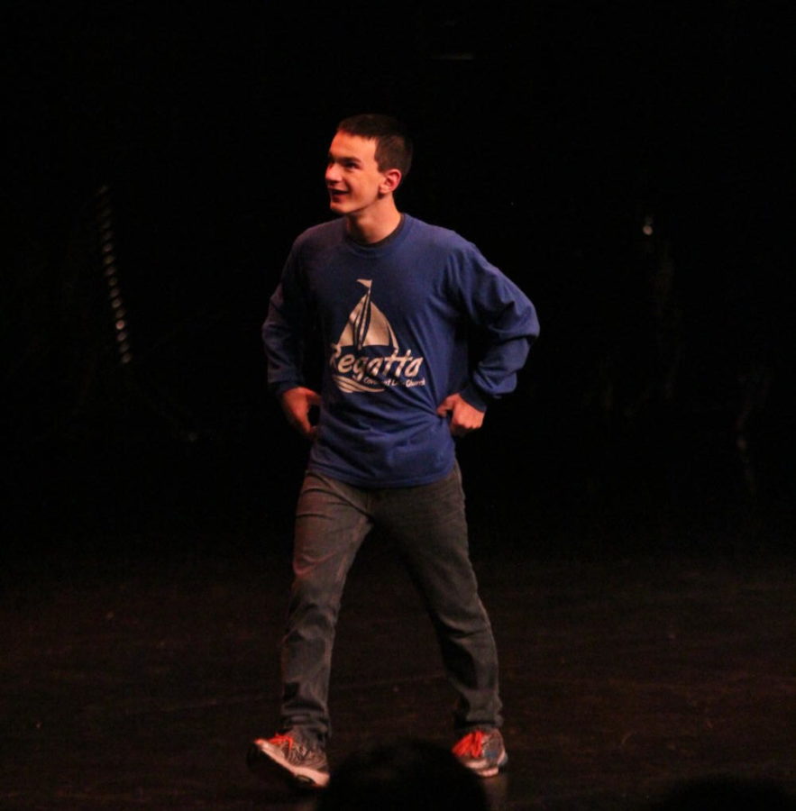 Senior Cal Coyne grins as he walks up on stage while the audience sings to him on his 18th birthday.