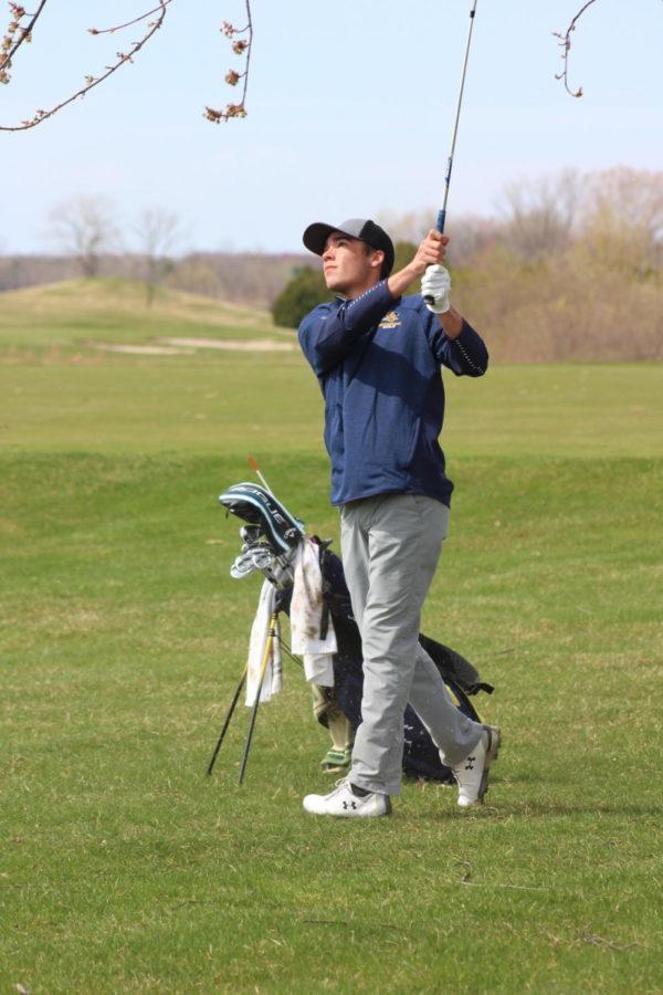 Senior Broc Wilson keeps an eye on his ball after his swing at a match in the 2019 season. 