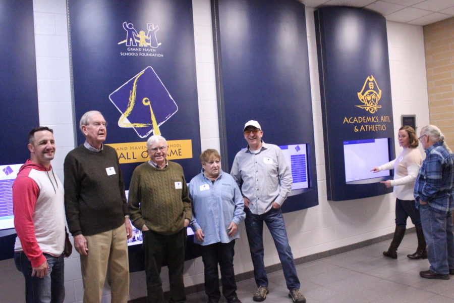 From left to right, John Cox, Don Anderson, John Angus, PhD, Sandy Huber and Dave Palmer stand in front of  the Grand Haven Hall of Fame.