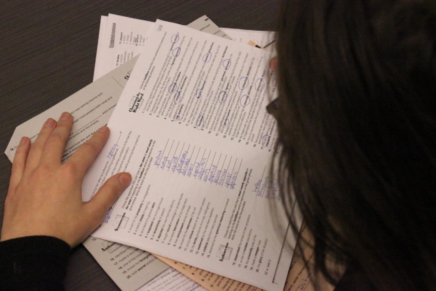 A student fills out vocabulary practice problems for an assignment. These packets can present unnecessary stress for students with scare use for the words.