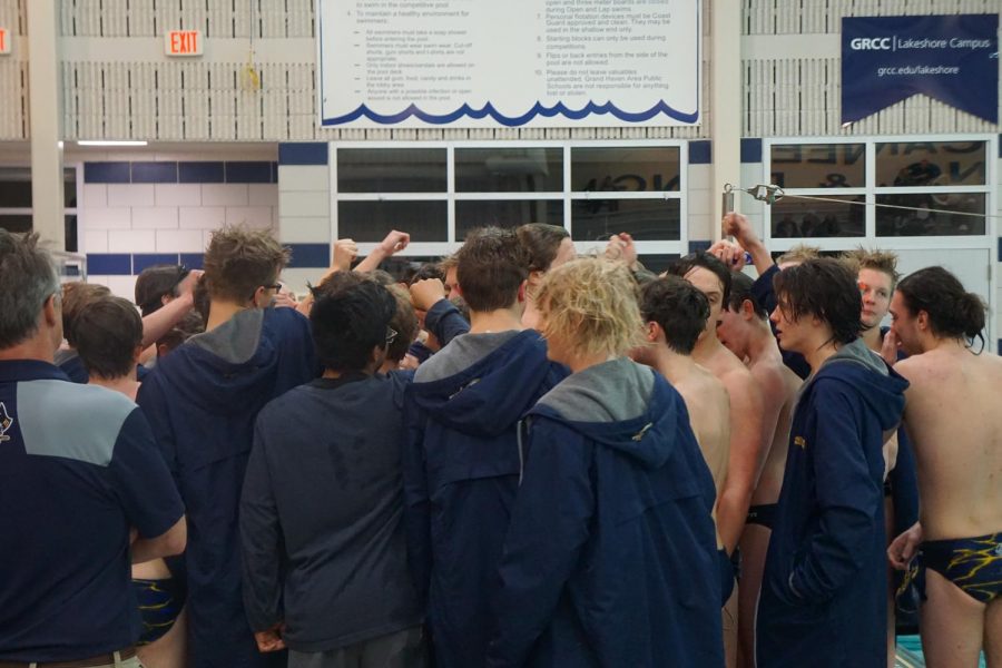 The boys swim team huddles up during a meet versus West Ottawa. The boys will take on the conference meet at Hudsonville high school on Feb. 27. 