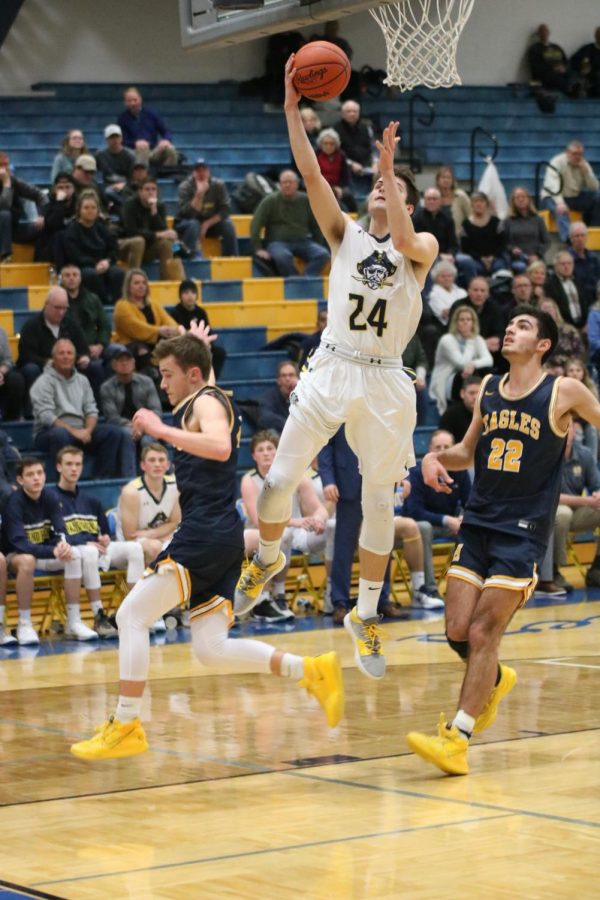 Owen Ross goes up for a layup during a conference rivalry game against Hudsonville. 