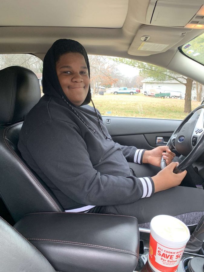 Freshman Justin Wheeler distracts himself the road to take a quick picture. Completing the 50 hours needed for Segment One of drivers training is something Wheeler hopes to accomplish during his time off. 