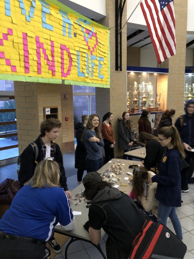 On National Leap of Kindness Day, DoRAK spread kindness to all by giving away Oreos donated by Sweet Temptations. Vice President Maddy Streng watches as students fill out cards to give with their Oreos to their friends. 
