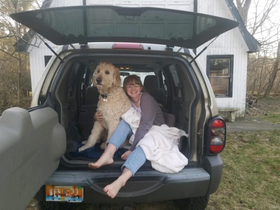 Junior Lilly Shepard poses from the back of her car with her dog Simon during the break from school due to COVID-19. 