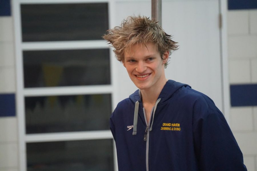 Senior Jack Timmer canot help but beam as the boys swim senior night ends; he is thankful for this season.