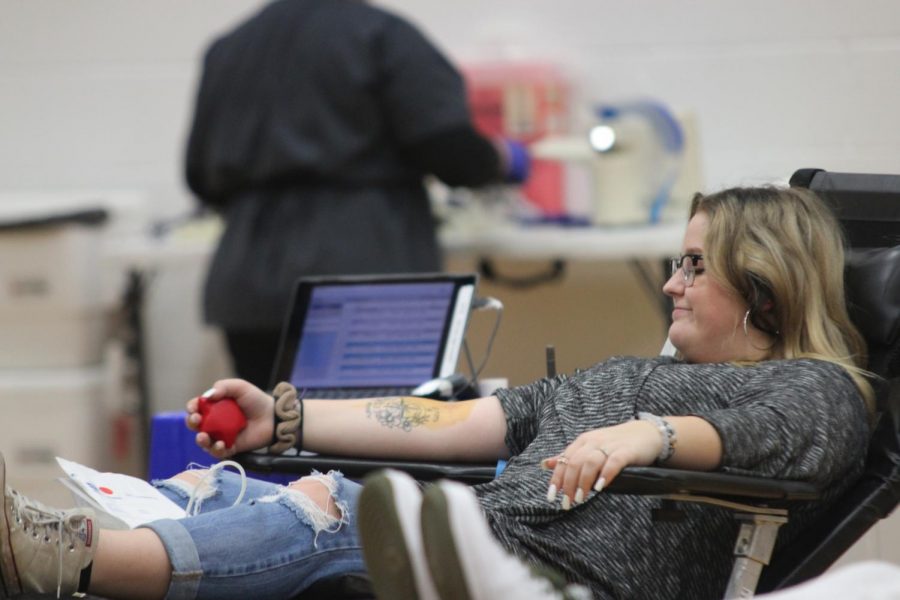 BLOOD FLOW: A student participating in a blood drive last year squeezes a stress ball to help the blood in her arm flow easier into the tube. 