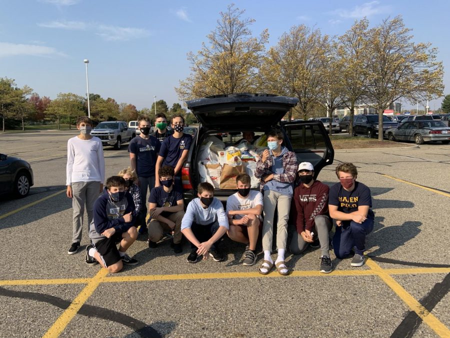 FOOD DRIVE: Members of the team pose in front of their haul after successfully completing their shopping. The trip was a quick one, due to the fact they had so many helping hands. 