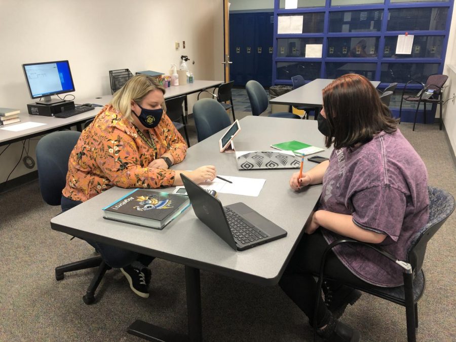 MATH MASTER: Math lab supervisor Jeanne Sherman helps a student with their math work. Students come in here to get help with their math work and get help getting caught up, Sherman said.