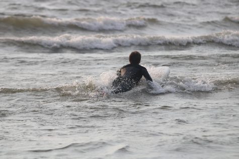Junior Jonah Sispera makes a splash surfing