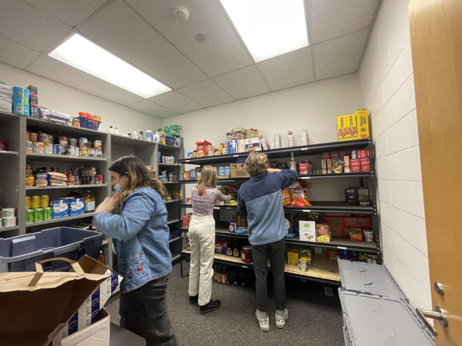 Bucs Care Food Pantry members Dolan Smits, Megan Voorhees and Johanna Weigle take inventory on the non-perishable goods in the food pantry. 