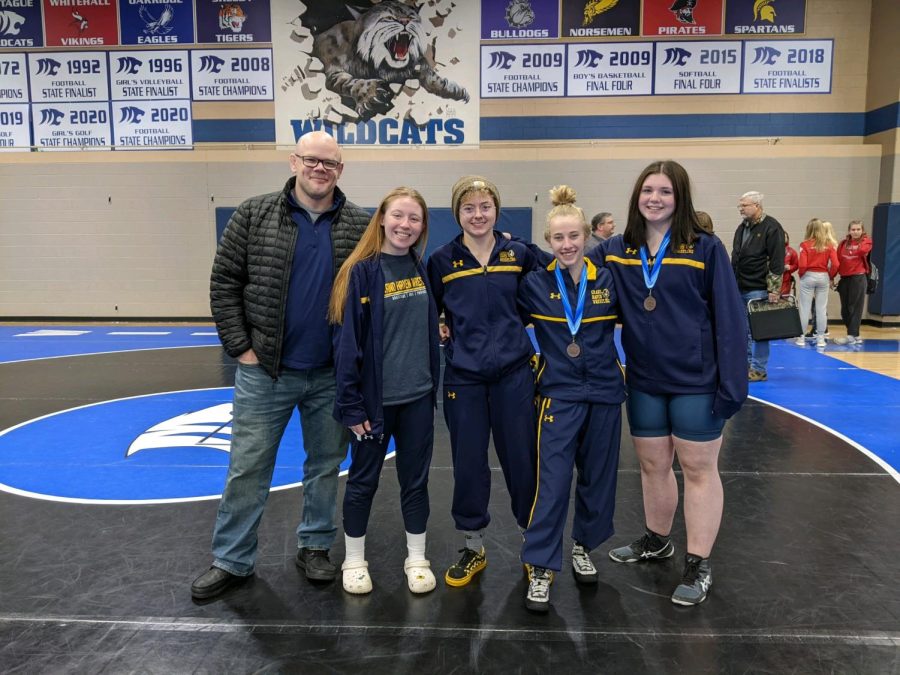 Triumph Four out of five girls wrestlers pose for a picture at the Lady Mat Cat in Montague Michigan.  