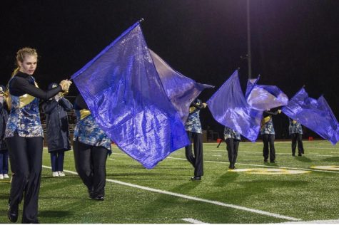 Color Guard members perform at a home football game. 